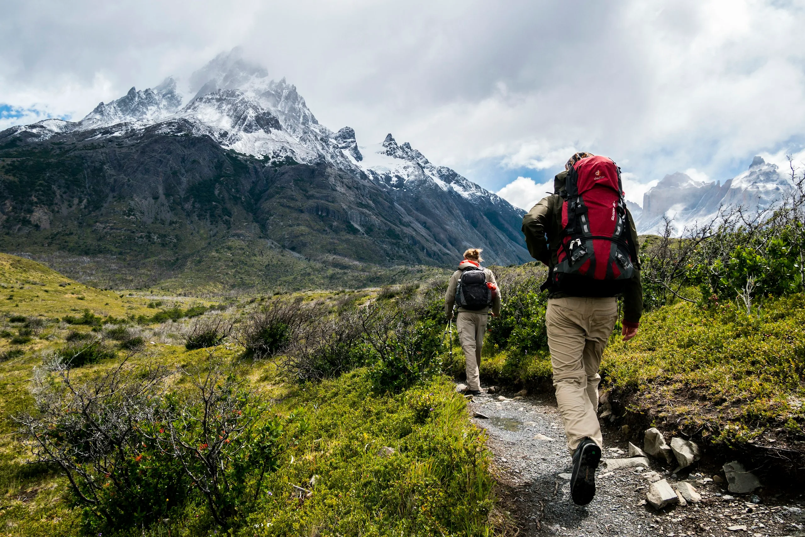 Hikers on a multi-day alpine trail with mountain hut